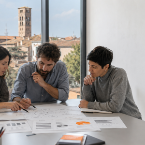 Tre colleghi analizzano cause ed effetti di un problema su grafici durante il corso di problem solving di AmniOs